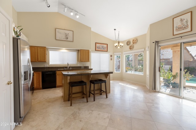 kitchen featuring a center island, a kitchen breakfast bar, hanging light fixtures, stainless steel refrigerator with ice dispenser, and black dishwasher