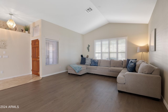 living room with dark hardwood / wood-style flooring and lofted ceiling