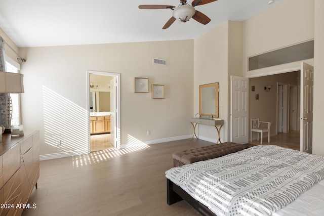 bedroom with high vaulted ceiling, ensuite bath, light hardwood / wood-style flooring, and ceiling fan