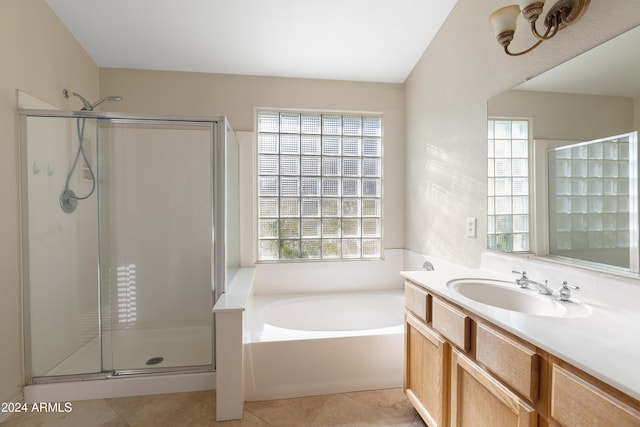 bathroom with shower with separate bathtub and a wealth of natural light