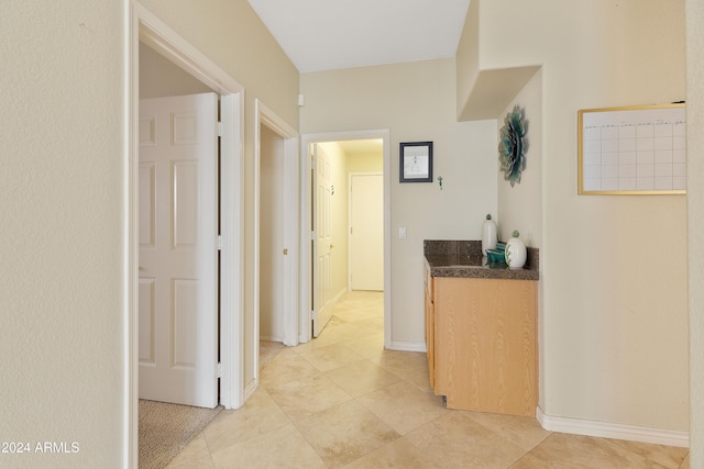 corridor featuring light tile patterned floors