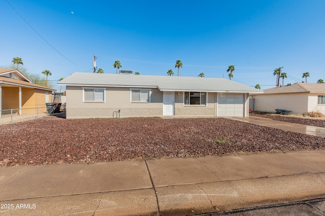 ranch-style house with a garage, driveway, and fence