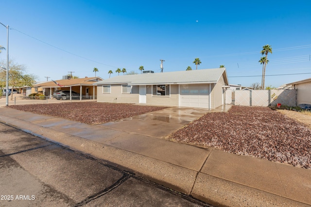 single story home featuring driveway, fence, and a gate