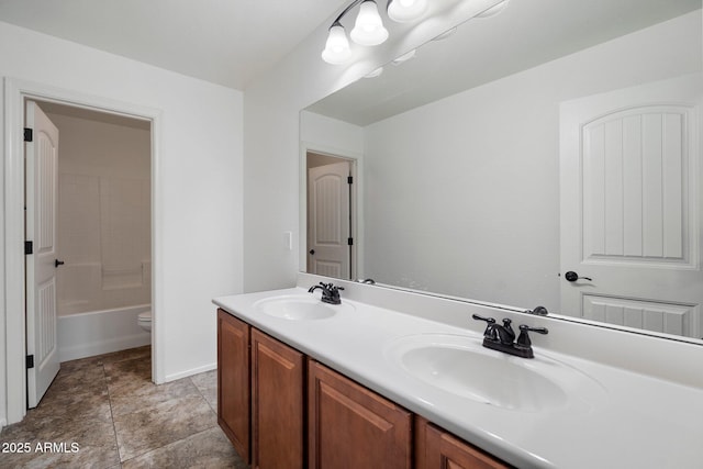 12217 W Planada Ln, Sun City, AZ 85373 - bathroom with double vanity, toilet, baseboards, and a sink