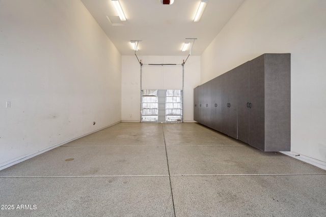 12217 W Planada Ln, Sun City, AZ 85373 - garage featuring baseboards