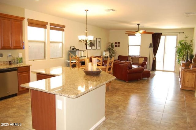 12217 W Planada Ln, Sun City, AZ 85373 - kitchen featuring light stone counters, brown cabinets, stainless steel dishwasher, decorative light fixtures, and ceiling fan with notable chandelier
