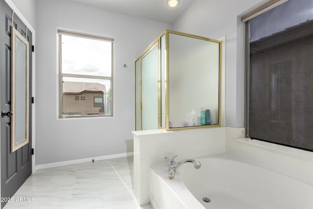 full bath featuring marble finish floors, a garden tub, a shower stall, and baseboards