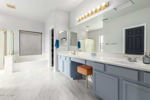 full bath featuring a shower stall, a garden tub, double vanity, and marble look tile flooring