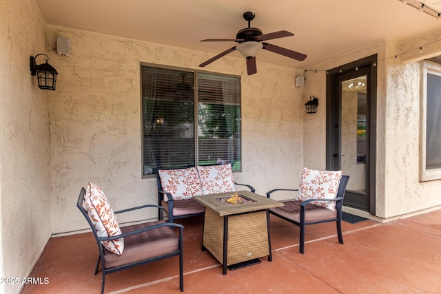view of patio / terrace featuring an outdoor fire pit and a ceiling fan