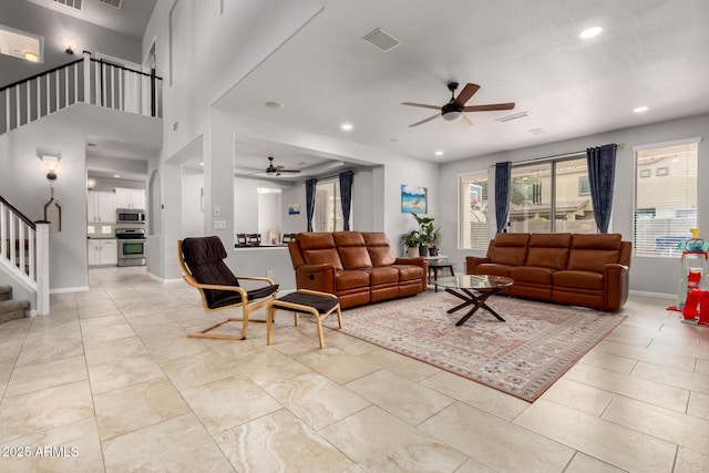 living room featuring a ceiling fan, stairs, recessed lighting, and light tile patterned floors