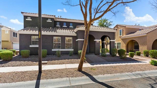 mediterranean / spanish-style house with a tile roof and stucco siding