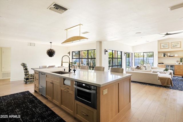 kitchen with appliances with stainless steel finishes, visible vents, and a sink