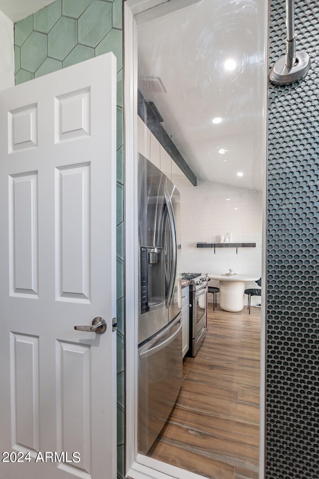 washroom featuring tile walls and dark hardwood / wood-style floors