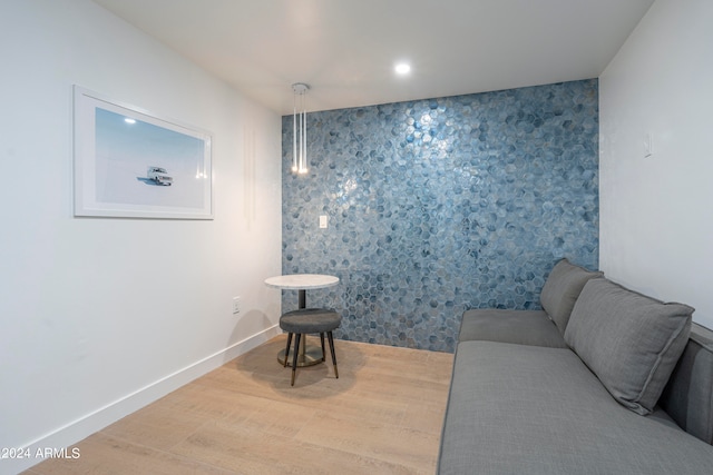 sitting room with wood-type flooring