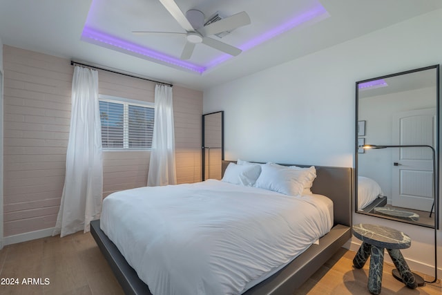 bedroom with ceiling fan and hardwood / wood-style flooring