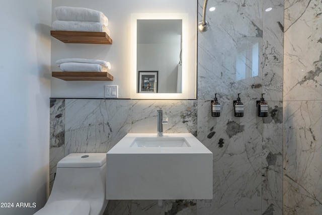 bathroom featuring tile walls, toilet, and vanity