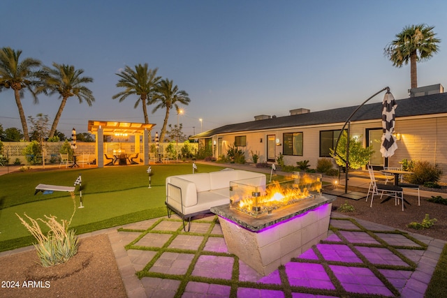 patio terrace at dusk with a playground and an outdoor living space with a fire pit