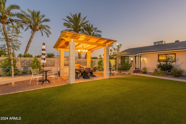 yard at dusk with a patio area and a pergola