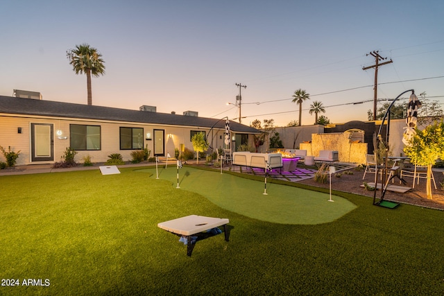 yard at dusk featuring a patio area and an outdoor hangout area