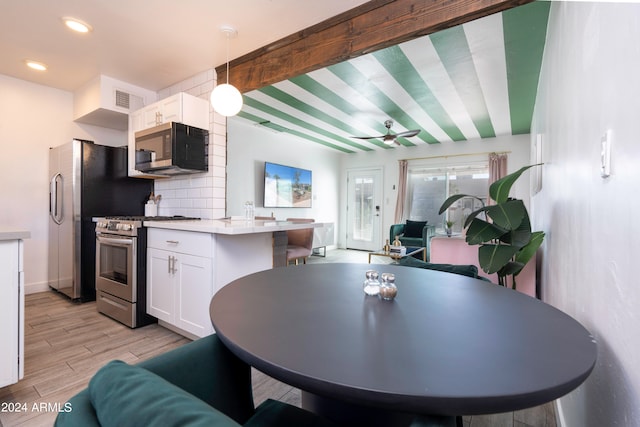 dining space featuring light hardwood / wood-style flooring and beam ceiling