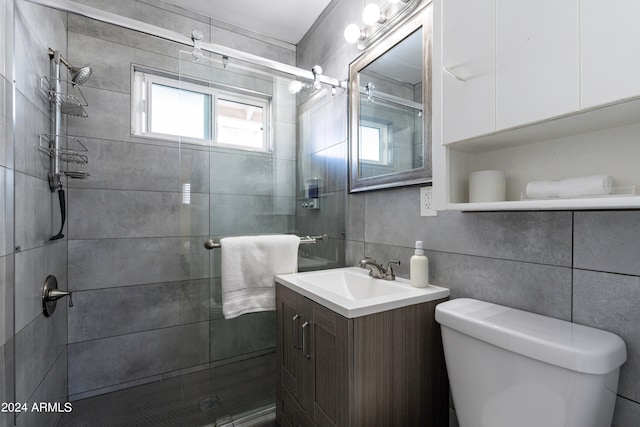 bathroom featuring toilet, an enclosed shower, vanity, backsplash, and tile walls