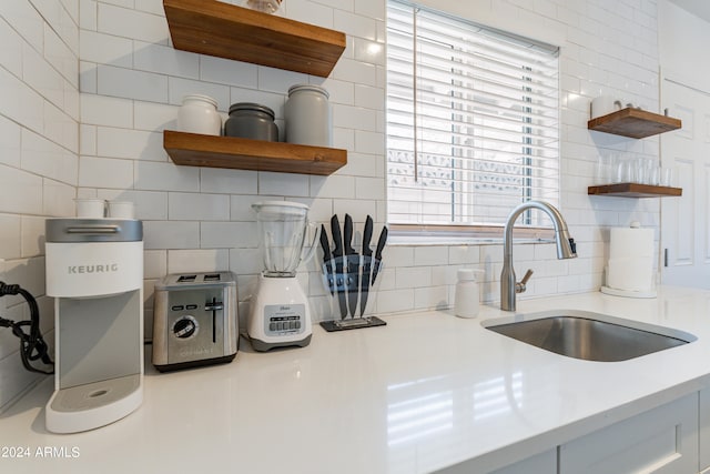 kitchen featuring sink and white cabinetry