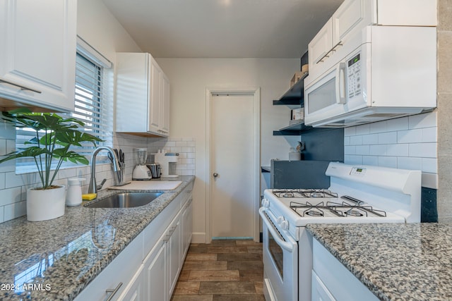 kitchen featuring dark wood-type flooring, sink, white appliances, and white cabinets