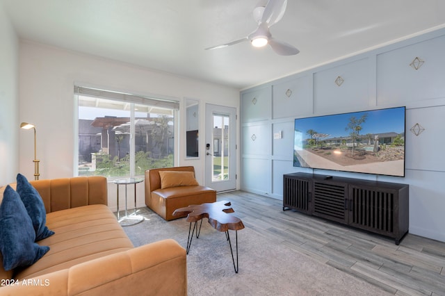 living room featuring light hardwood / wood-style flooring and ceiling fan