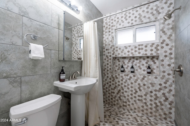 bathroom featuring tile walls, walk in shower, and toilet