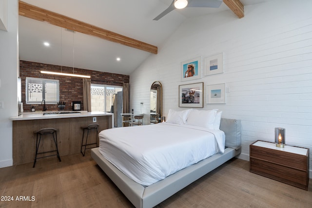 bedroom featuring brick wall, wood-type flooring, beam ceiling, high vaulted ceiling, and ceiling fan