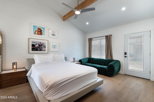 bedroom featuring multiple windows, ceiling fan, lofted ceiling with beams, and light hardwood / wood-style flooring