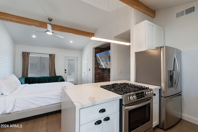 kitchen with appliances with stainless steel finishes, light stone counters, white cabinetry, and ceiling fan