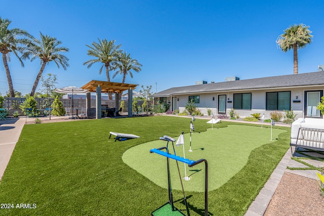 view of community with a pergola and a yard