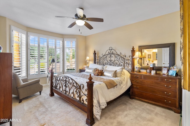 bedroom with ceiling fan and light colored carpet