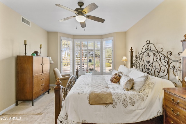 bedroom with ceiling fan and light colored carpet