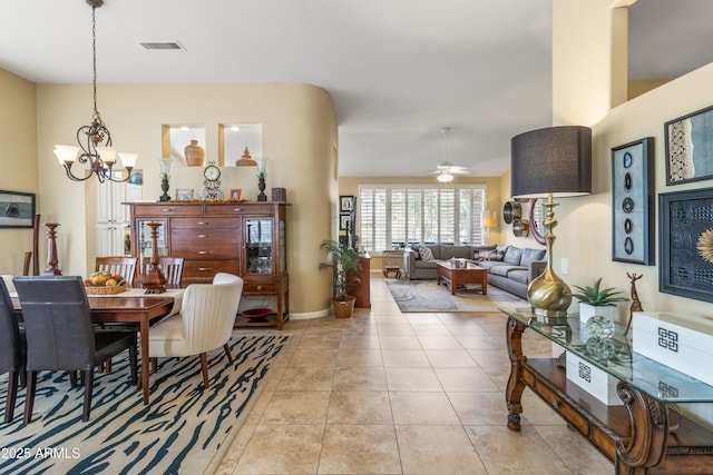 dining area with light tile patterned floors and ceiling fan with notable chandelier