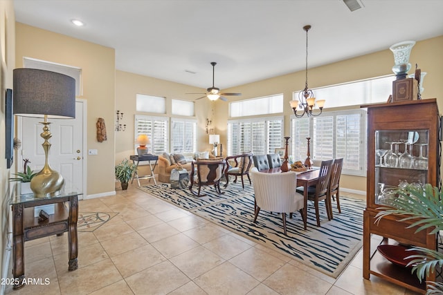 dining space with light tile patterned floors and ceiling fan with notable chandelier