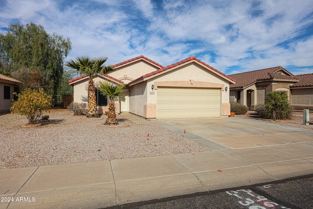 mediterranean / spanish-style home with a garage