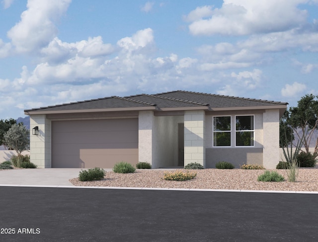 prairie-style home with an attached garage, a tiled roof, concrete driveway, and stucco siding