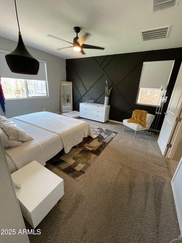 bedroom with visible vents, carpet floors, and ceiling fan