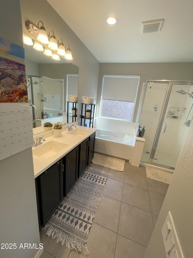 bathroom featuring visible vents, a sink, tile patterned flooring, a shower stall, and a bath