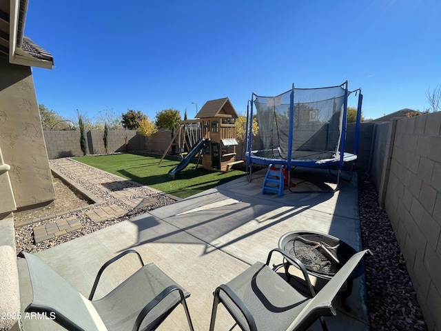 view of patio / terrace featuring a fenced backyard, a playground, and a trampoline