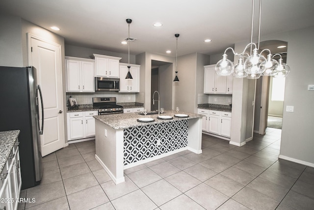 20471 E Carriage Way, Queen Creek, AZ 85142 - kitchen with stainless steel appliances, a sink, decorative backsplash, light tile patterned flooring, and white cabinetry