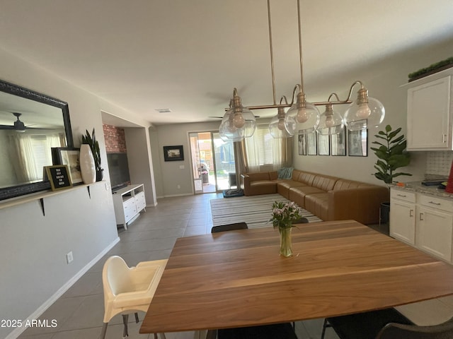 tiled dining space with visible vents and baseboards