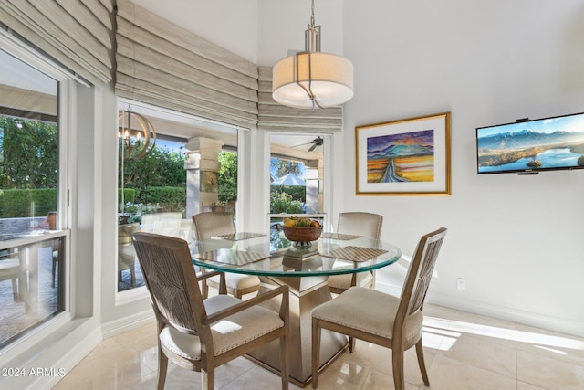 dining area with light tile patterned floors and a chandelier