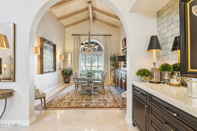 dining space featuring a chandelier, light tile patterned floors, lofted ceiling with beams, and wood ceiling