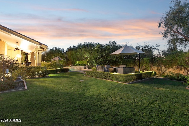 yard at dusk with area for grilling