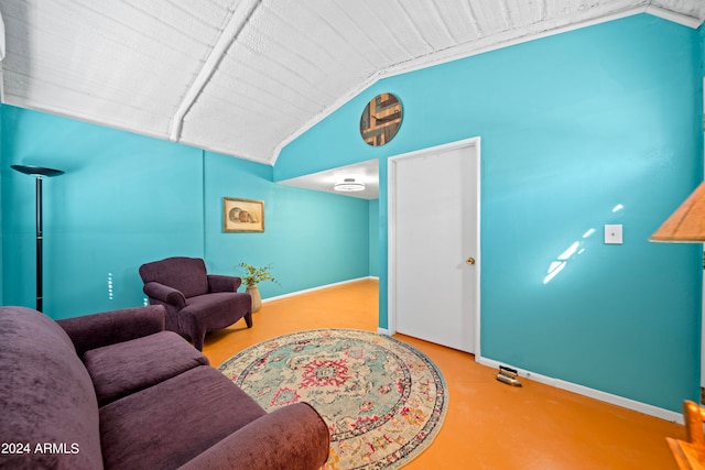 living room featuring lofted ceiling and concrete flooring