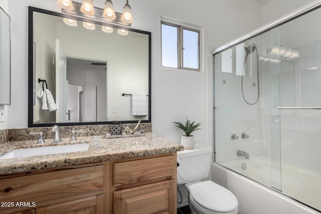 full bathroom with vanity, combined bath / shower with glass door, and toilet