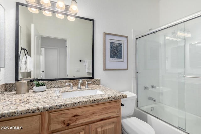 full bathroom with vanity, toilet, and combined bath / shower with glass door